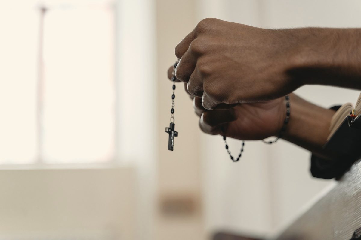 Hands holding prayer beads