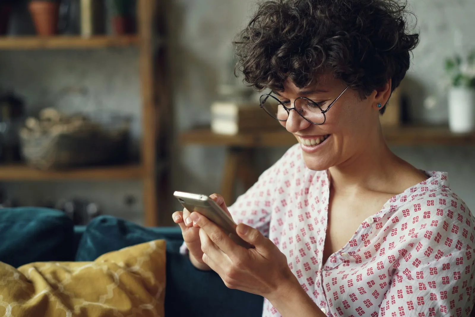 Smiling woman checking appointment details on her phone at home