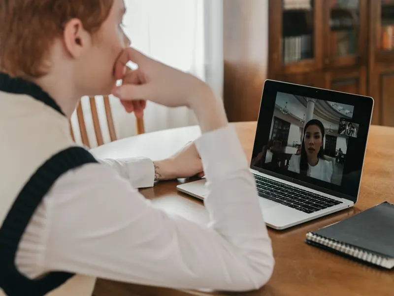 Person on a calm video consult on a laptop at home
