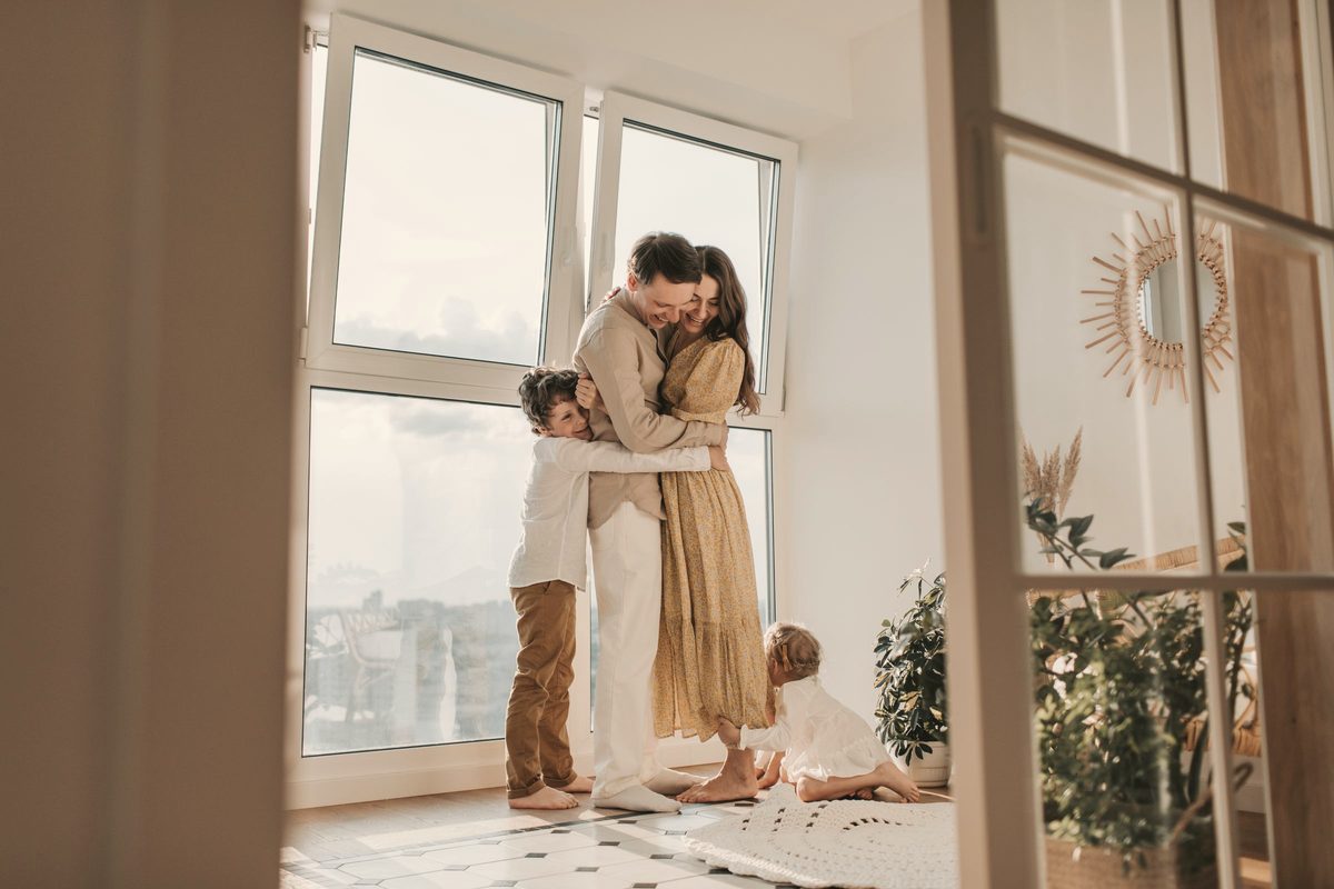 Family sharing a warm hug at home