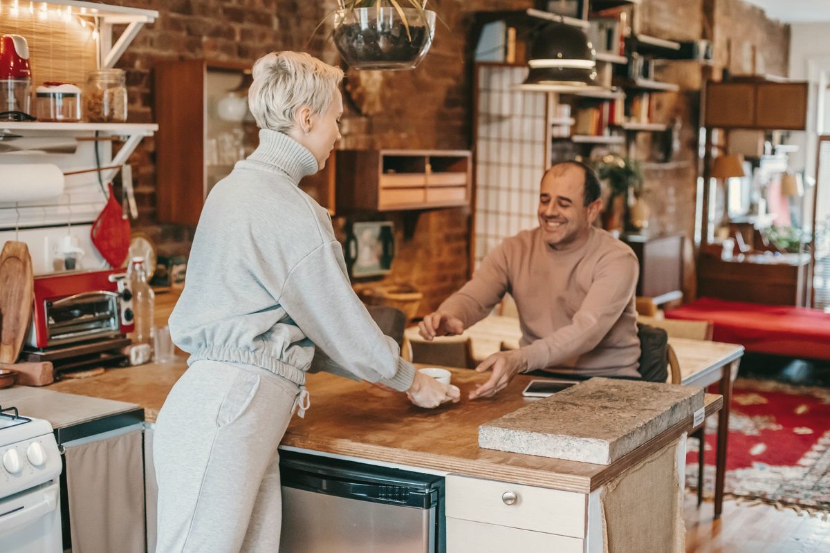 Friends sharing a coffee in the kitchen