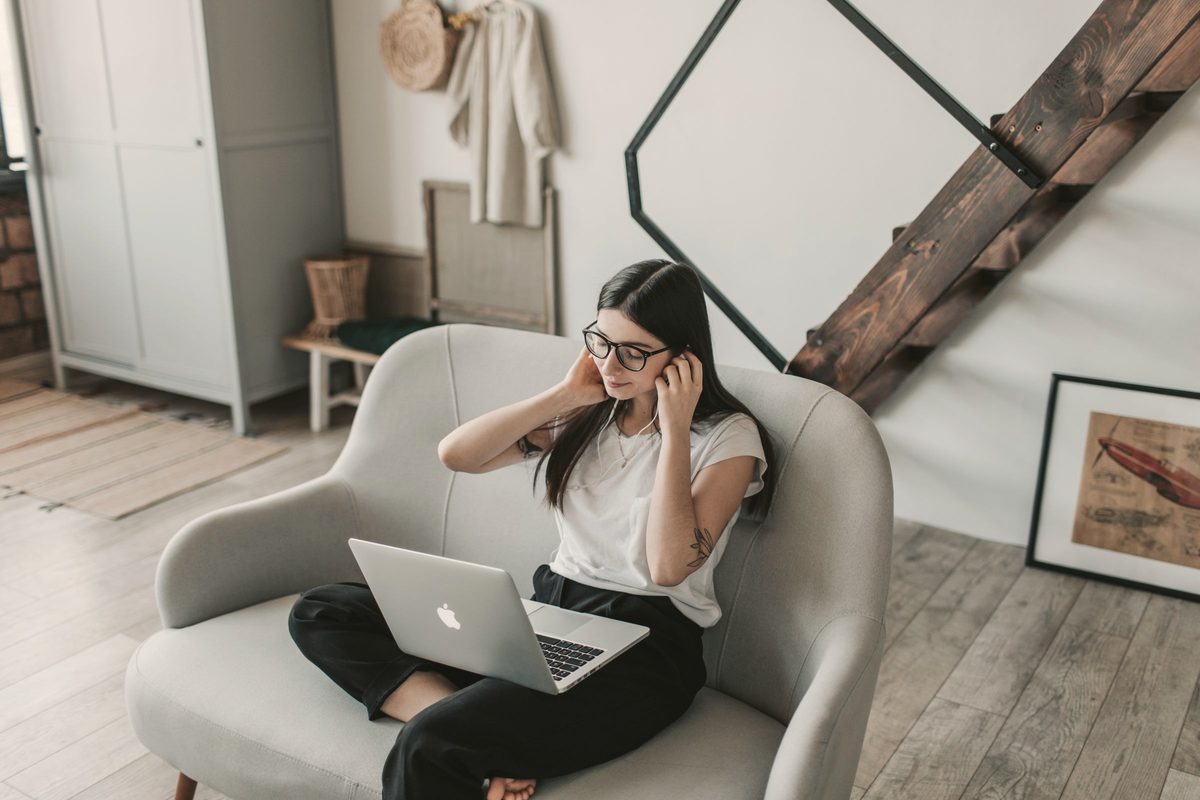 Woman relaxing in an armchair with her laptop