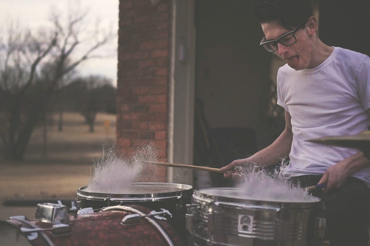 Person playing on drums during daytime