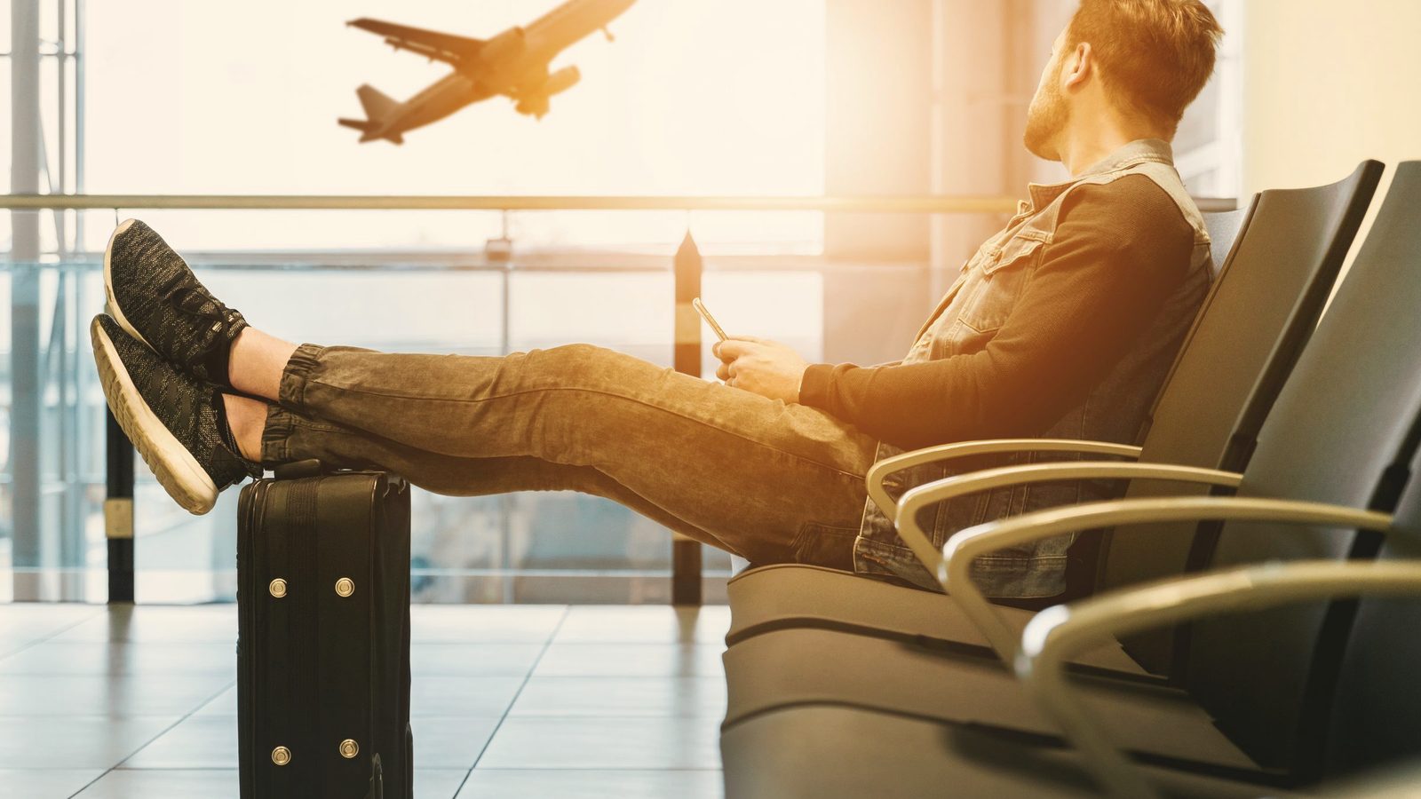Man in airport waiting for boarding on plane