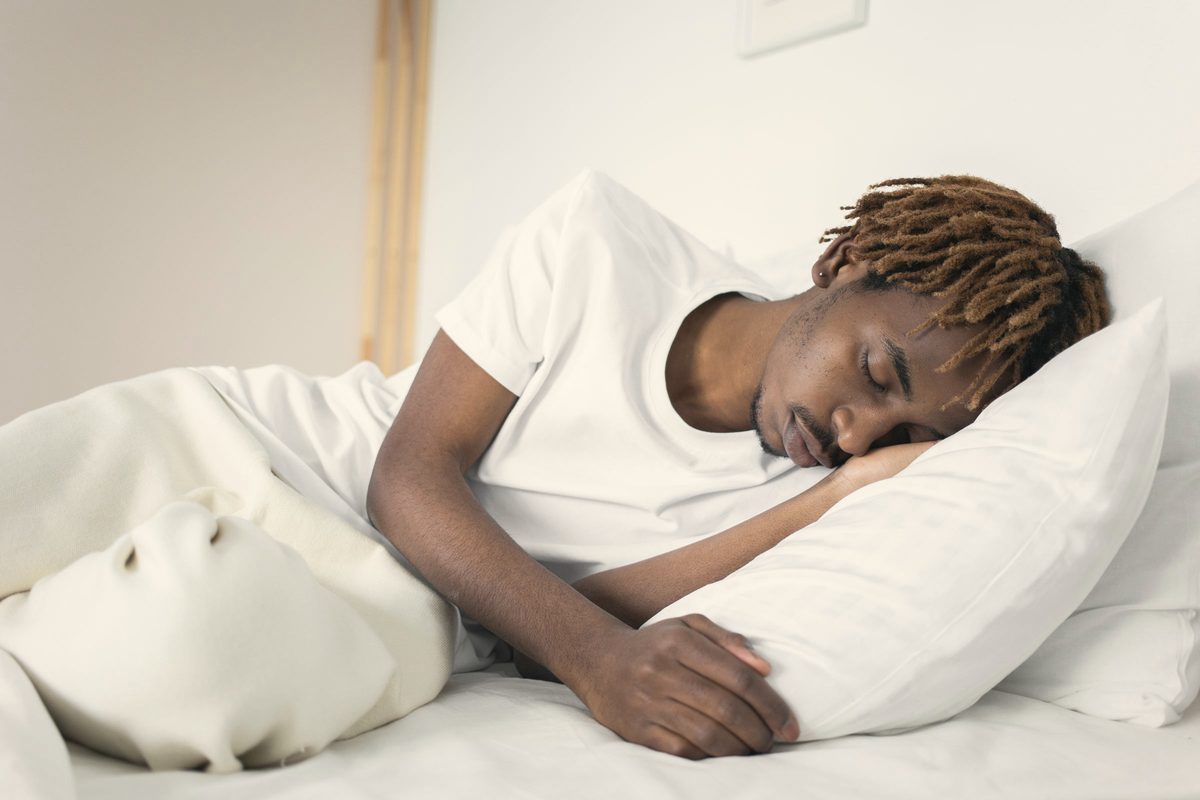 Man sleeping soundly on white pillows