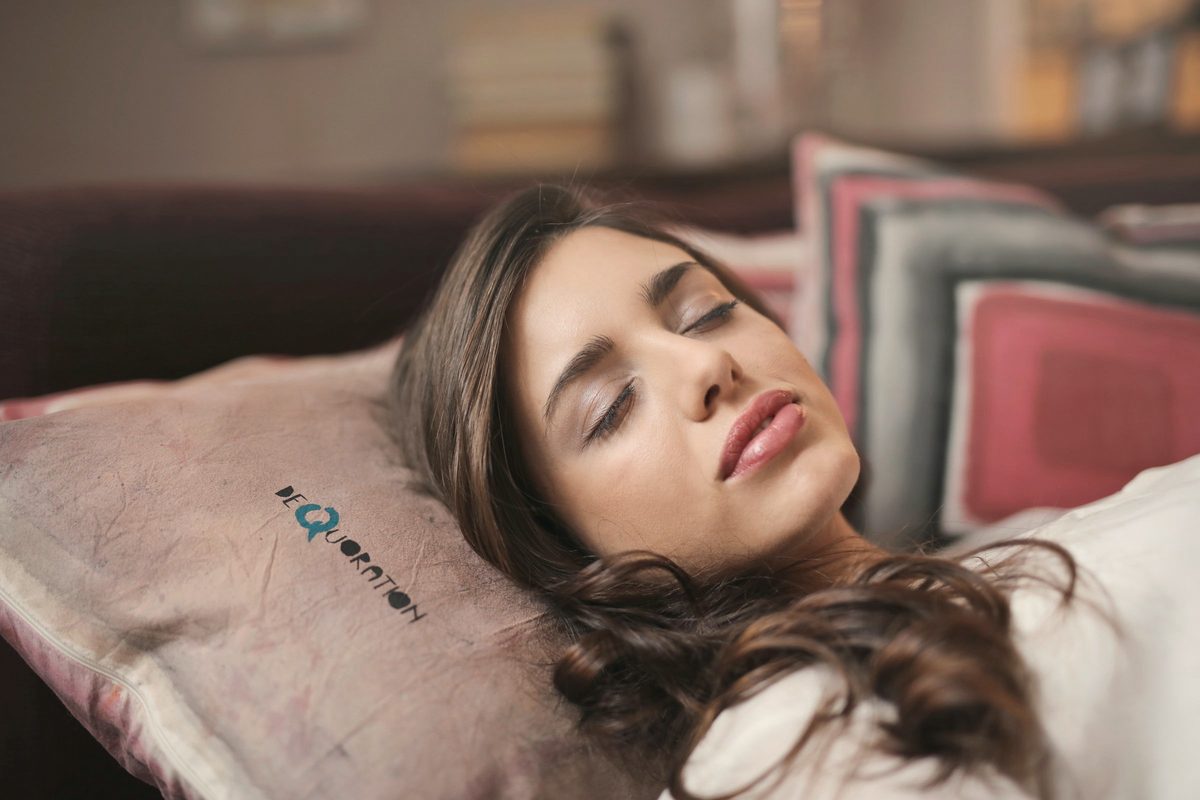 Woman asleep on a cosy bed