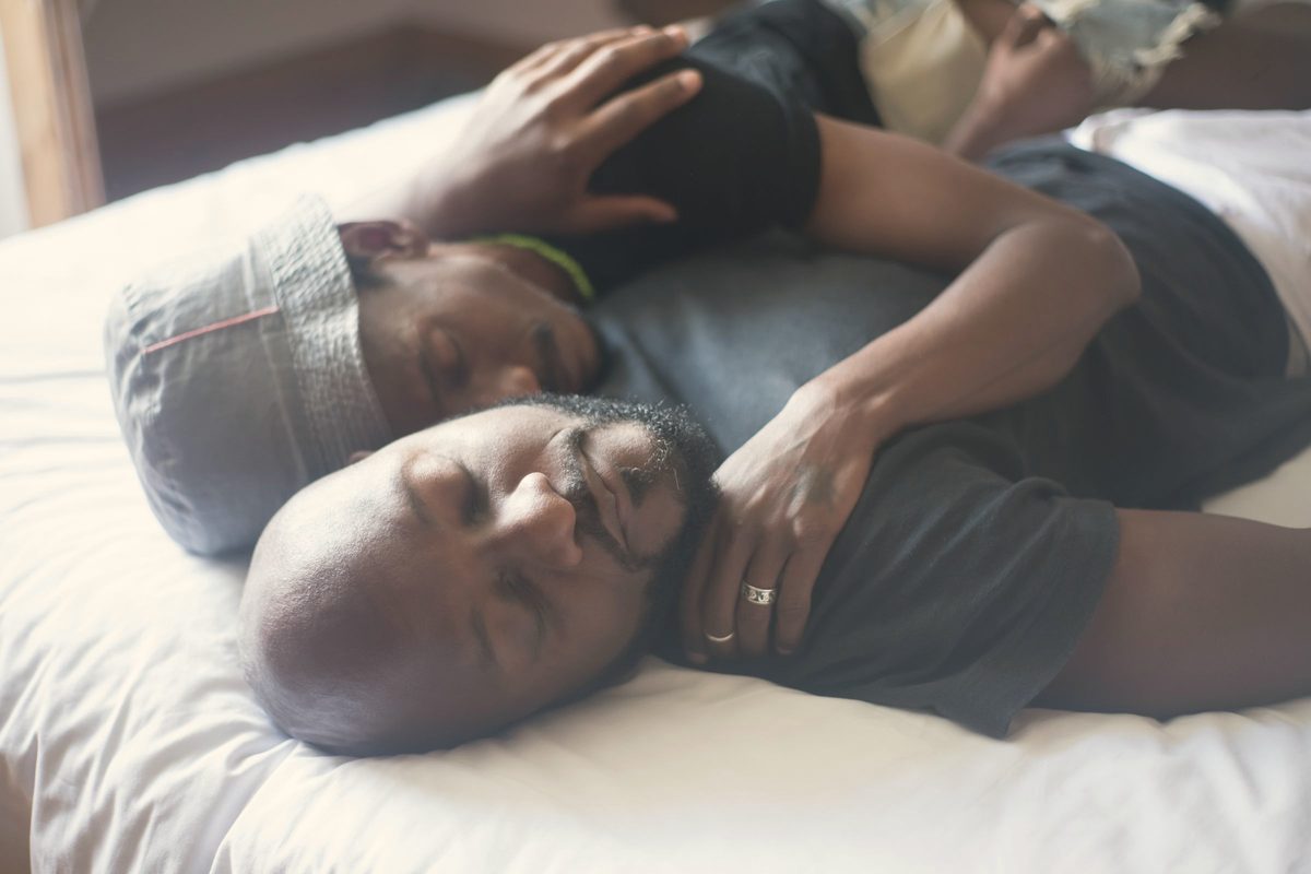 A couple hugging and sleeping on bed