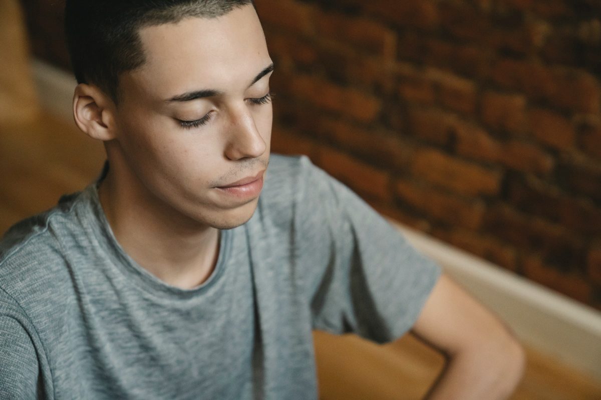 Man sitting quietly at home with his eyes closed
