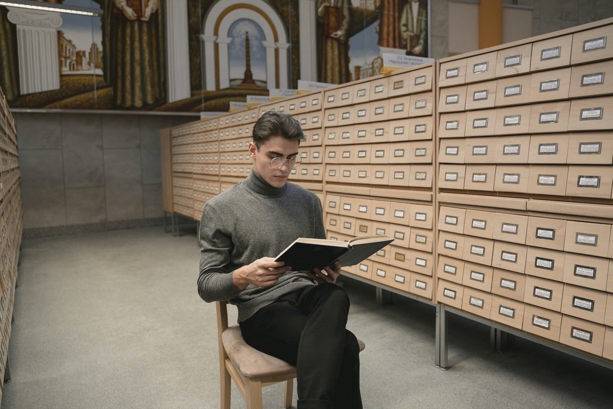 Man reading a book in a quiet library