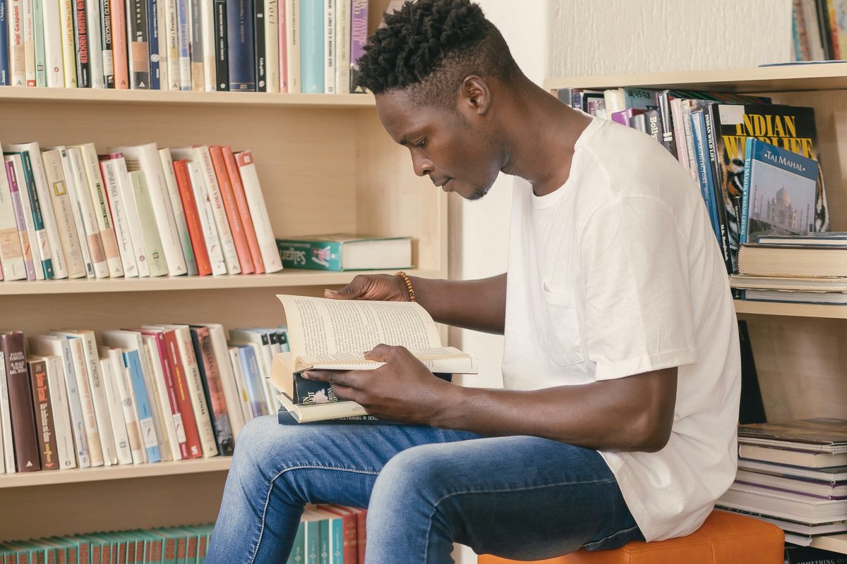 Man reading a book in a library