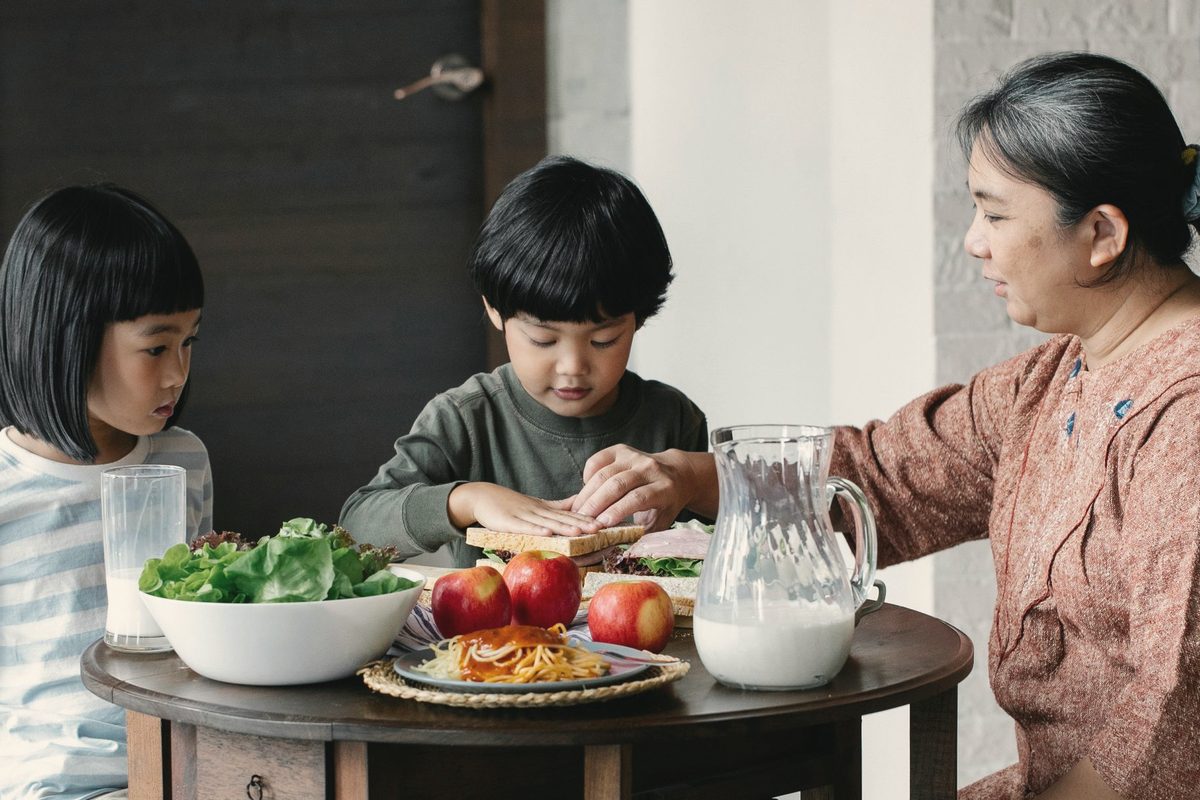 Mother preparing breakfast for her children
