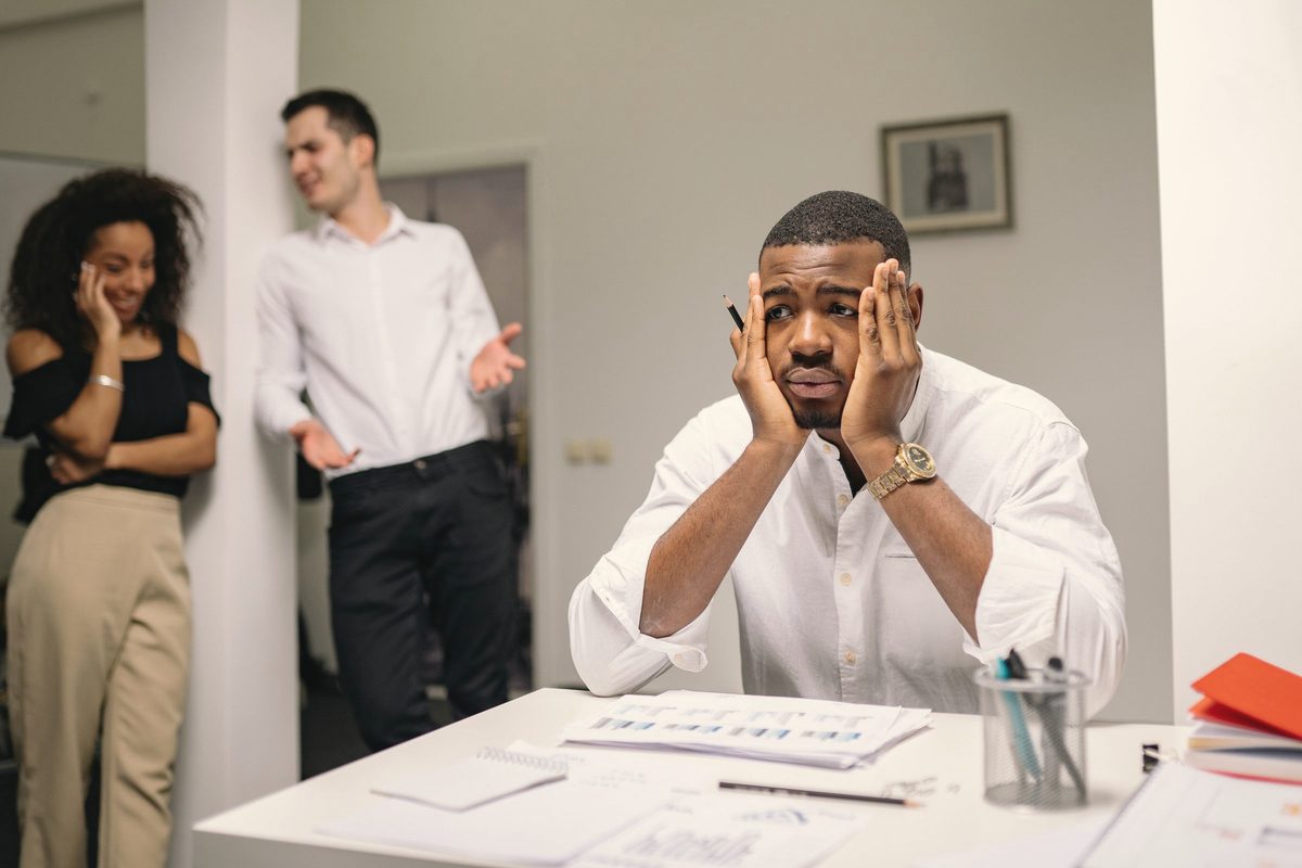 Worried man holding his face at his desk