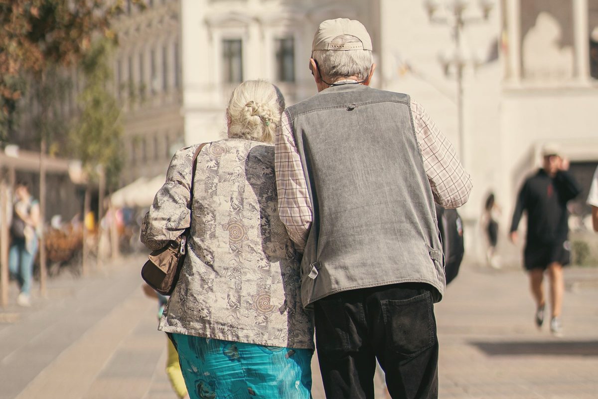 Older couple walking together arm in arm