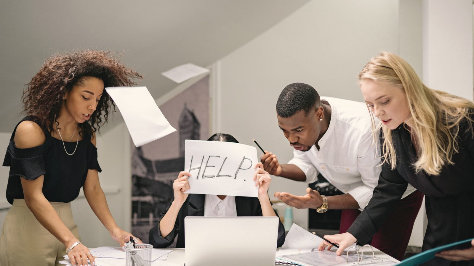 People talking to a stressed coworker in the workplace