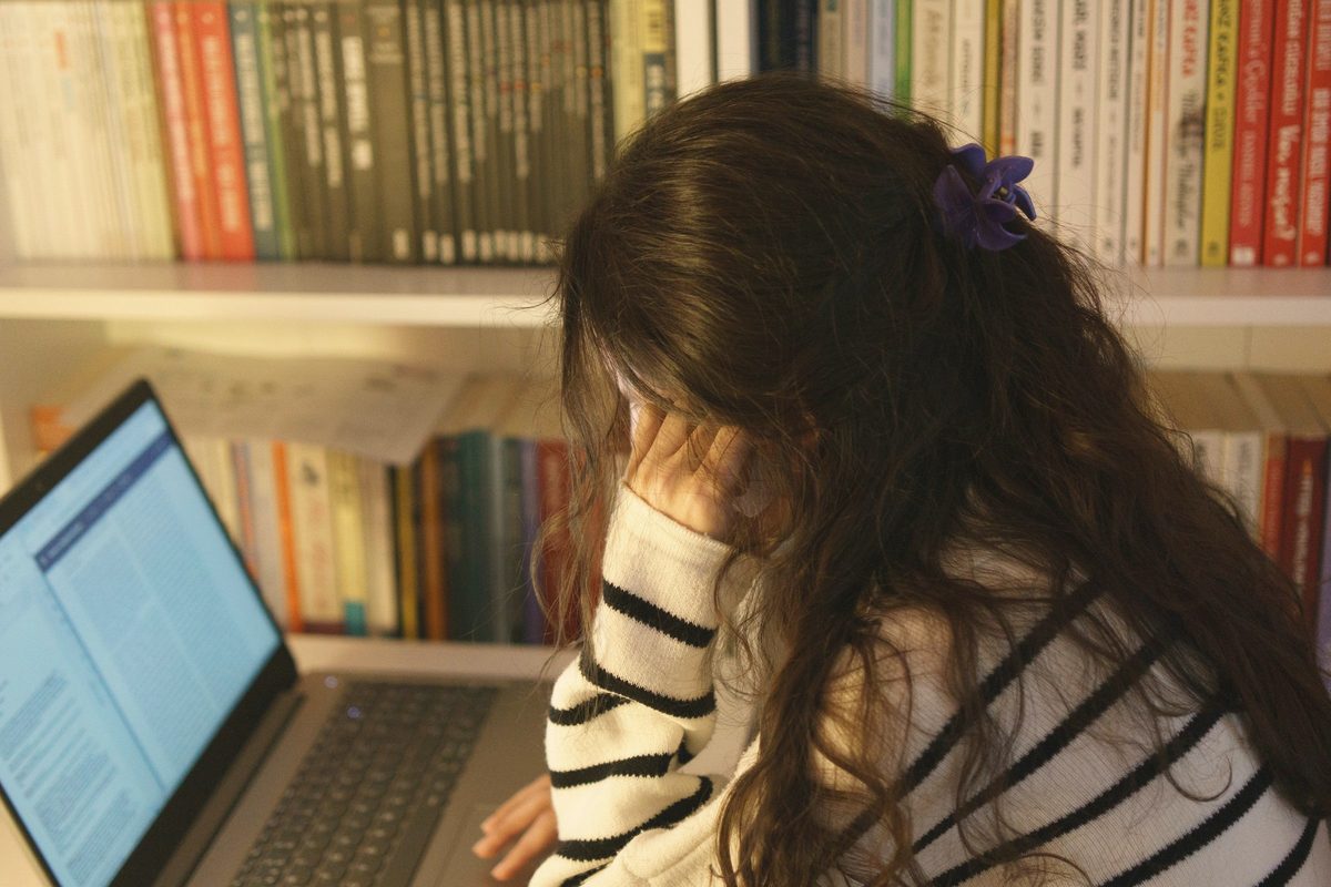Woman studying at a laptop in a library