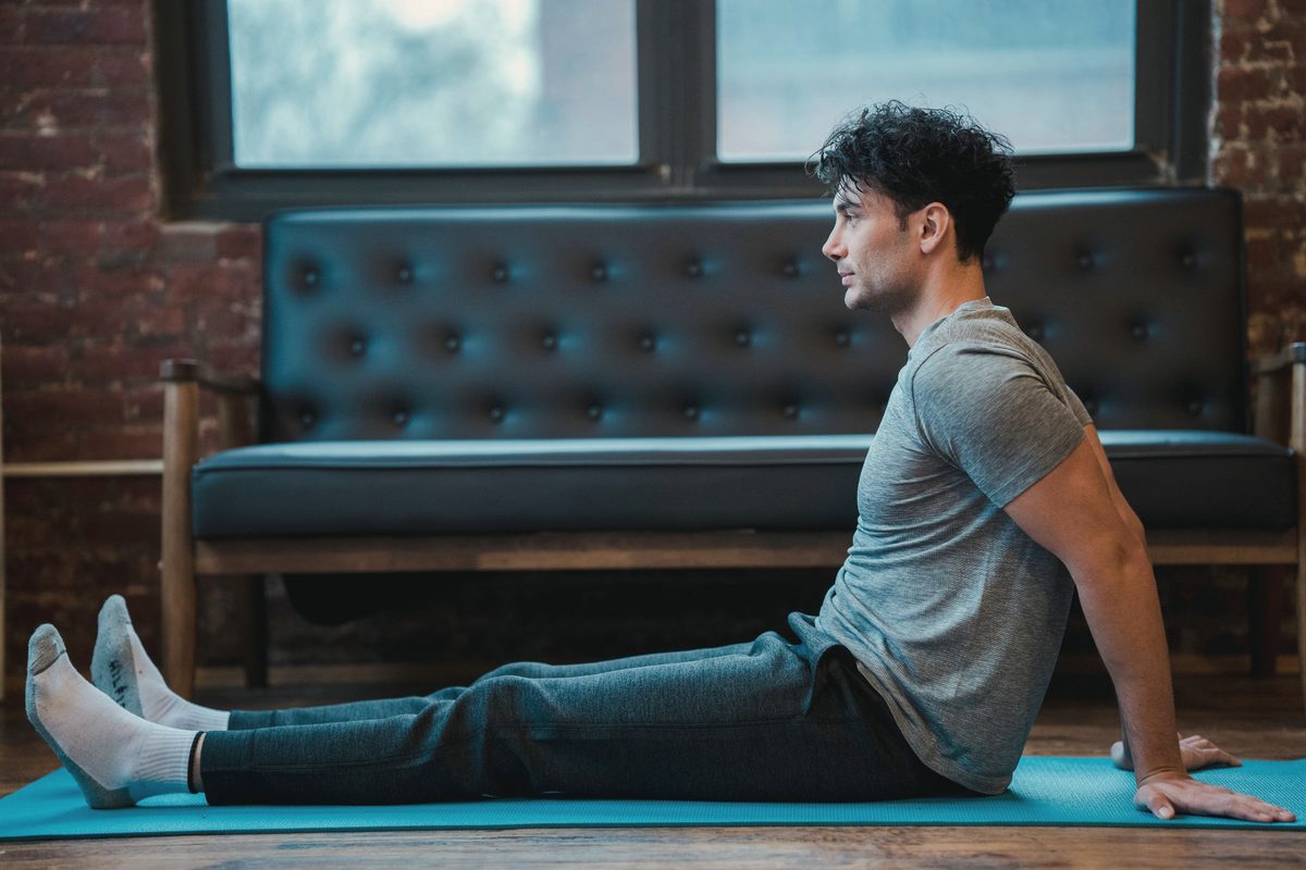 Focused man leaning on hands while resting after exercise