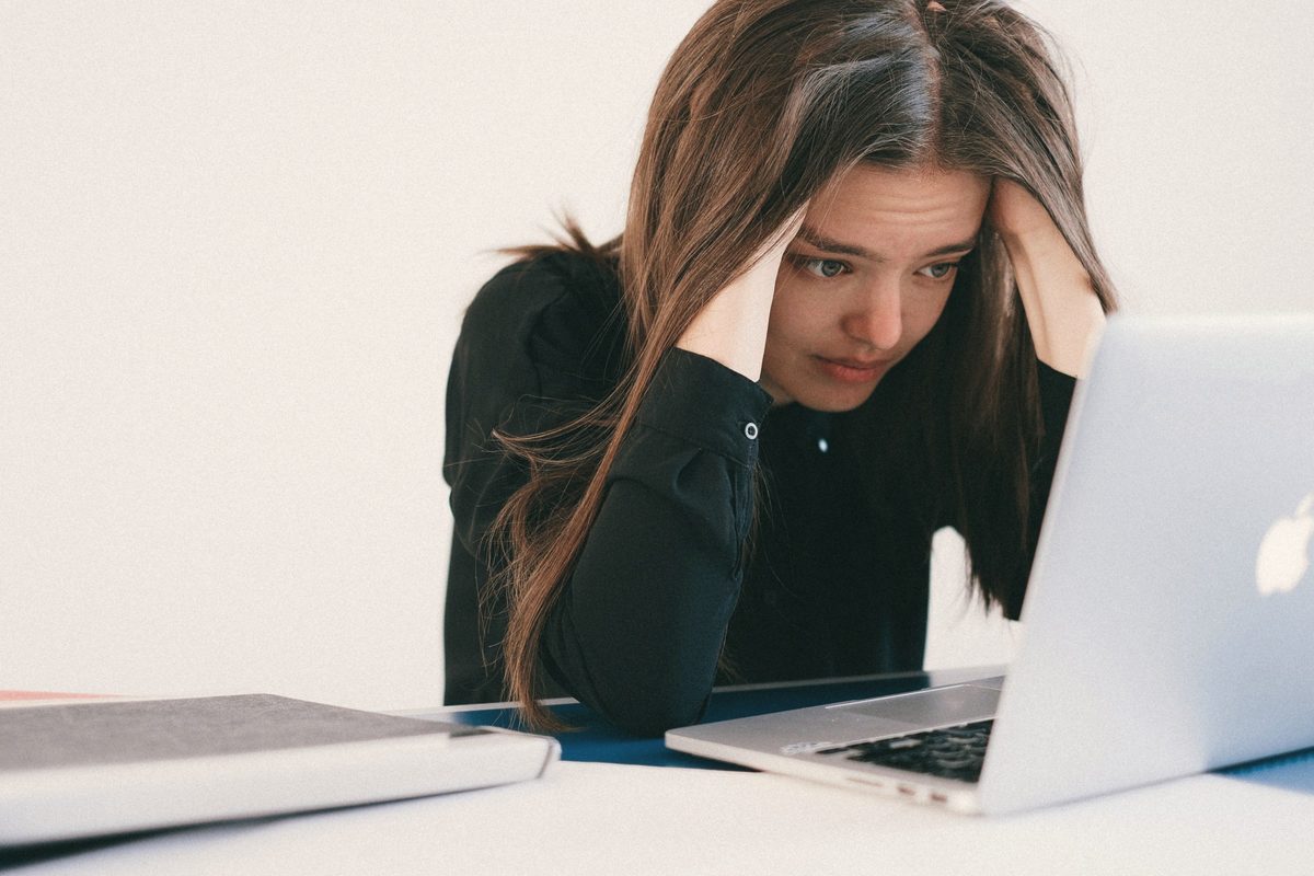 Stressed woman looking at a laptop
