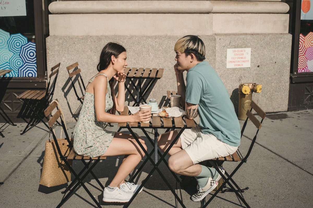 Couple having breakfast together at a cafe table