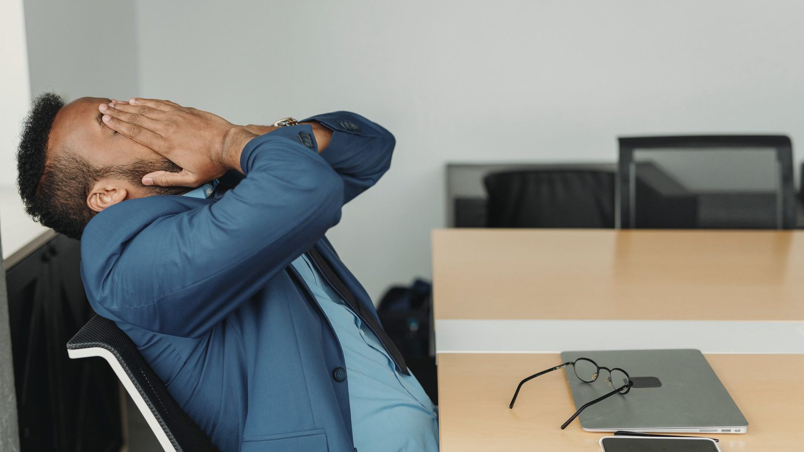 A stressed businessperson sitting at a desk