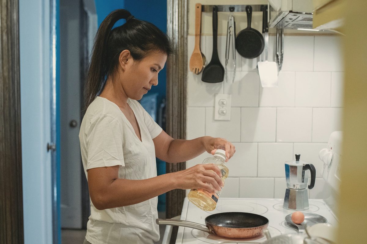 Focused woman cooking in kitchen