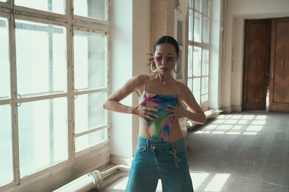 Woman dancing freely in a sunlit studio