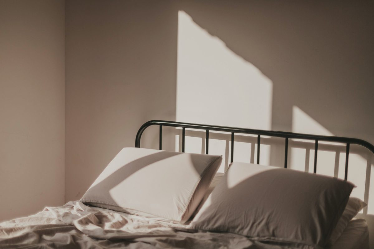 Morning sunlight falling across bed linen