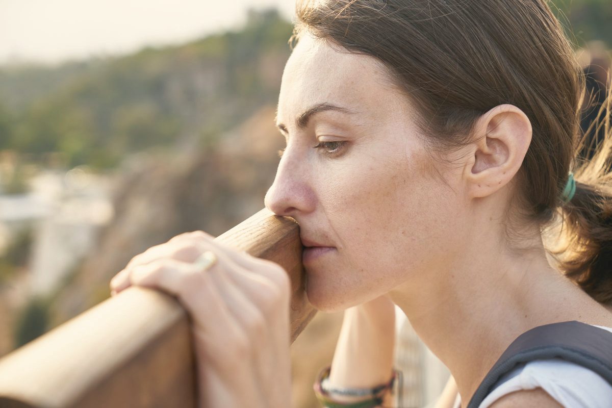 Woman pausing to breathe at a lookout