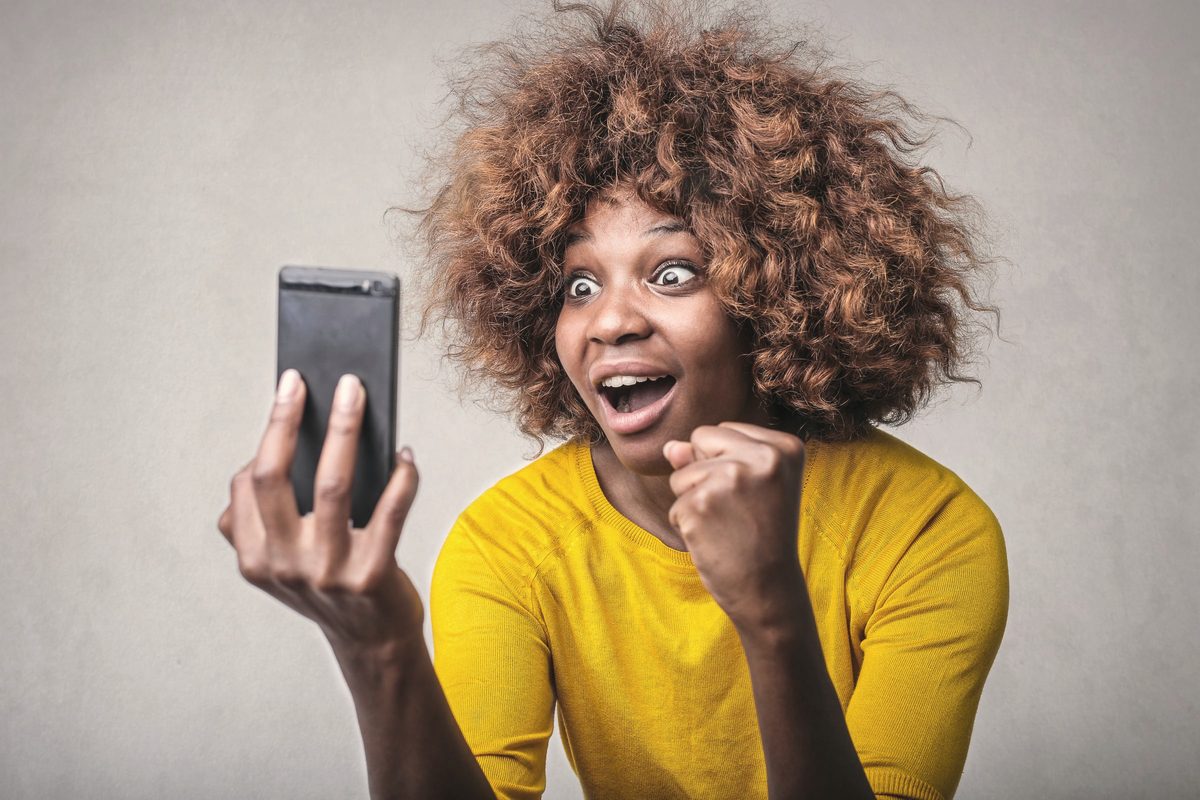 Surprised woman reacting to something on her phone