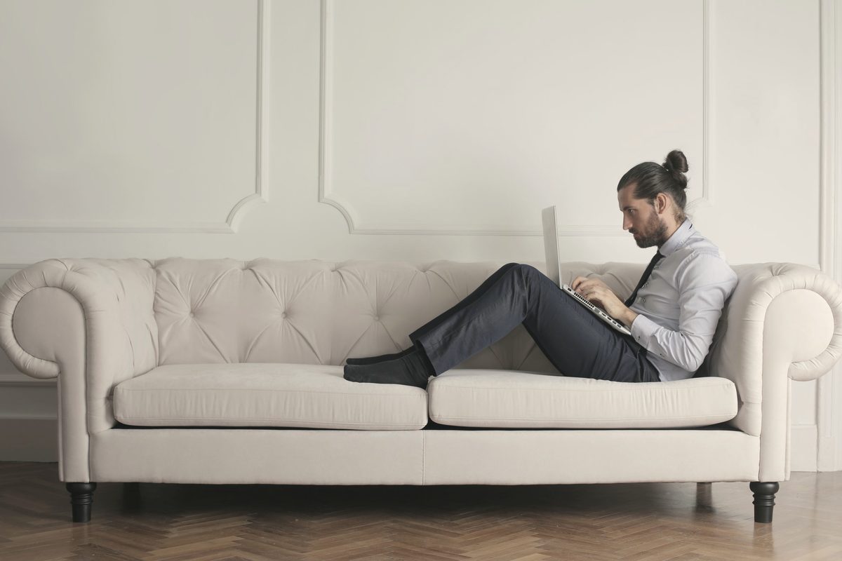 Man resting on a white sofa