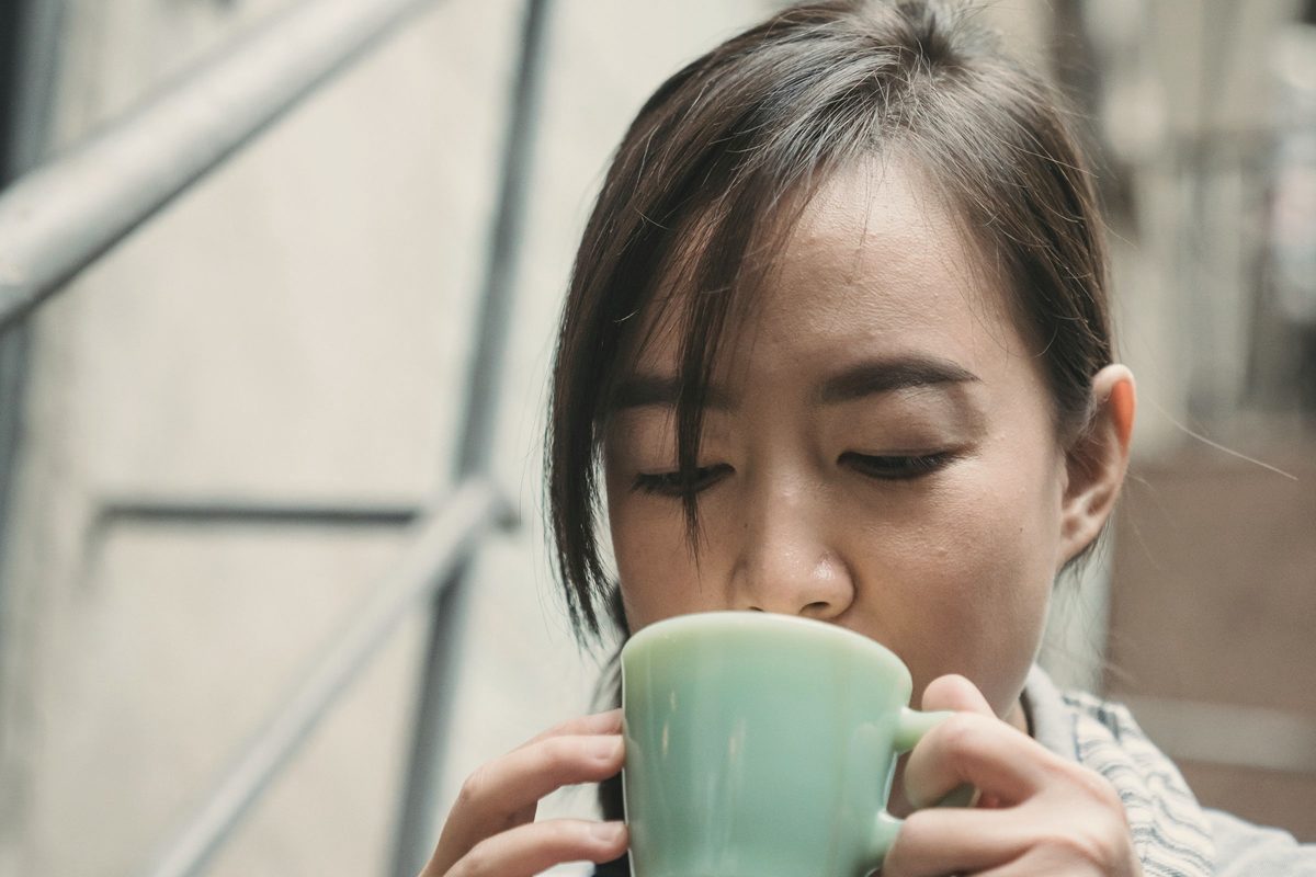 Woman sipping from a mug during a coffee break