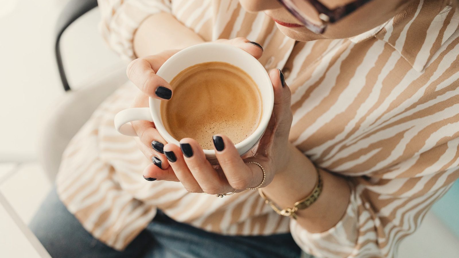 A woman holding a cup of coffee