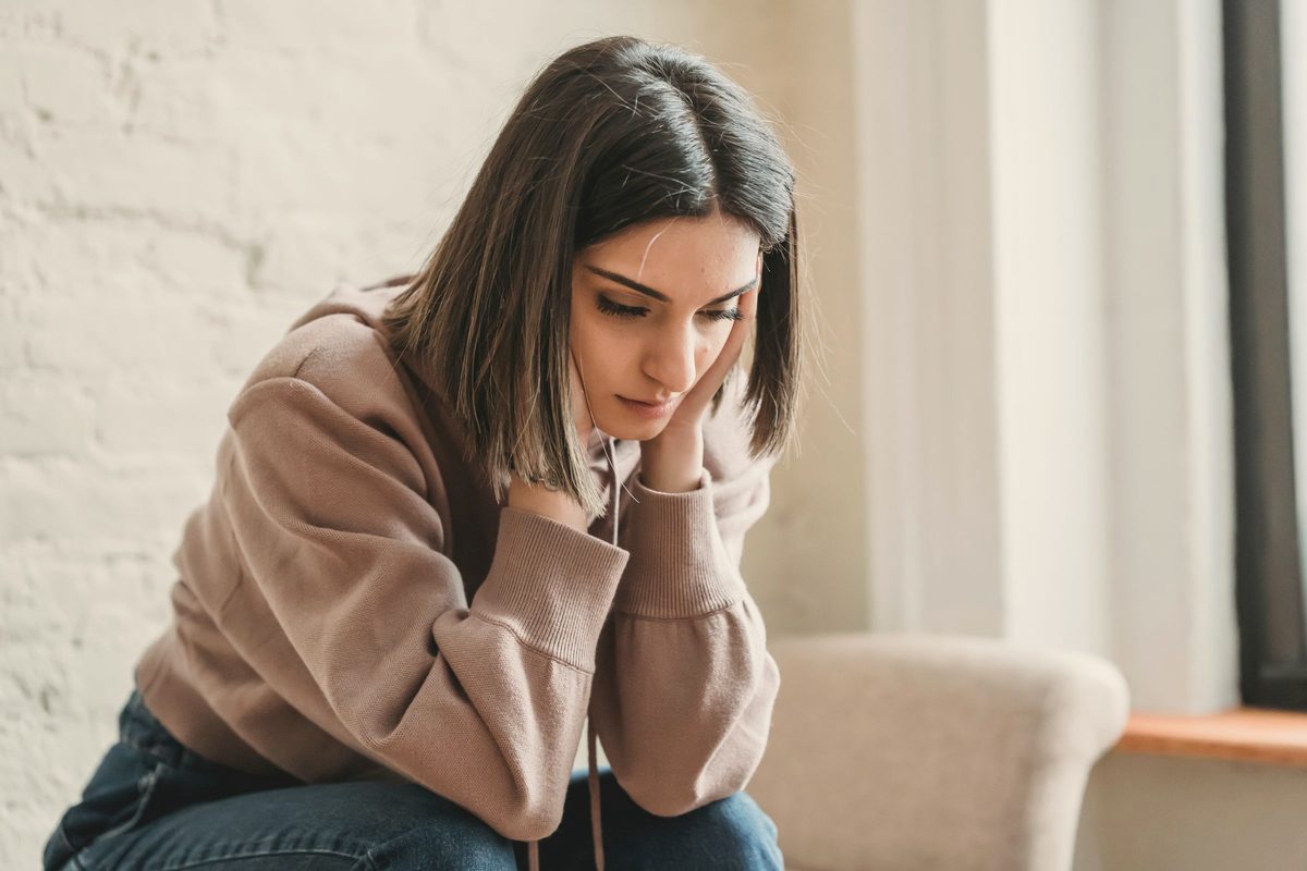 Sad woman sitting on couch
