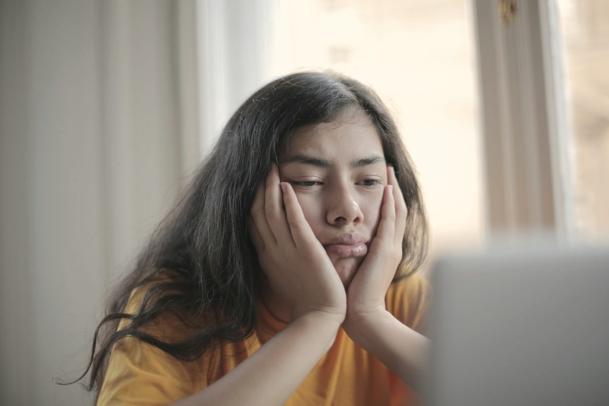 Woman watching a video on her laptop at home