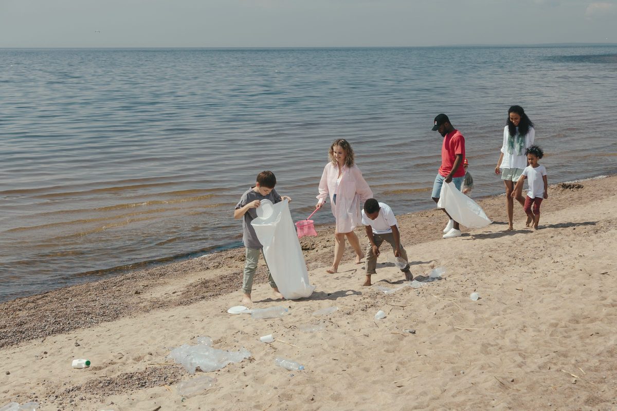 People at the beach picking up the trash