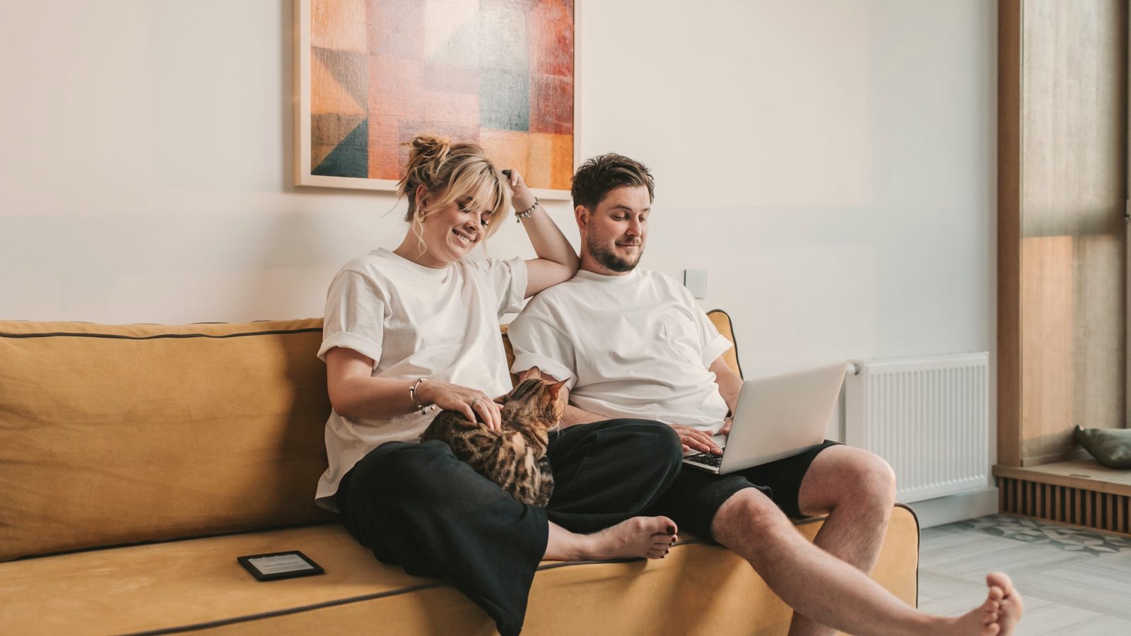 Couple sitting together on a sofa at home