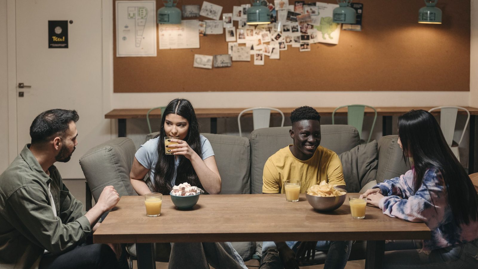 A group of friends sitting on the couch while having conversation