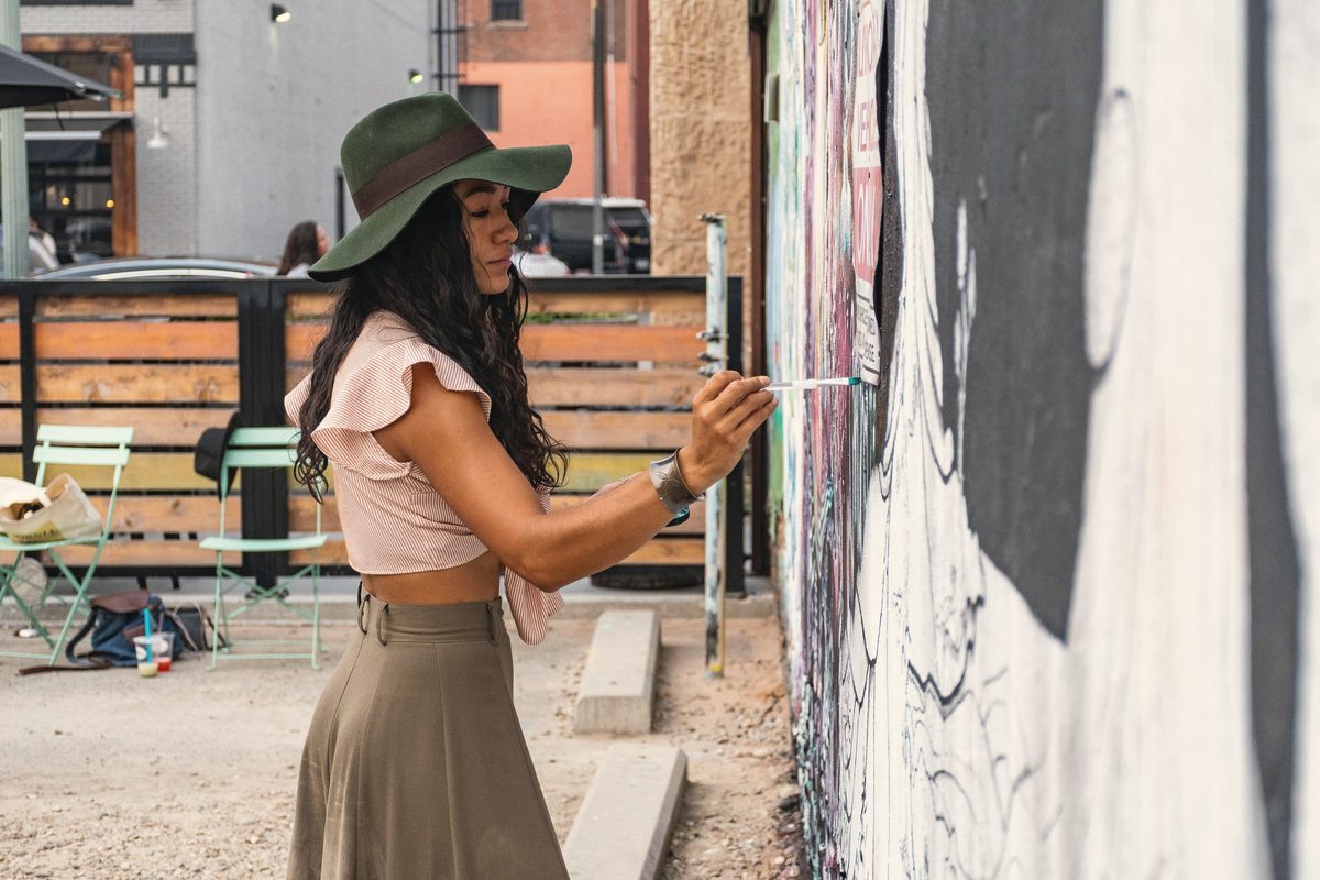 Woman painting on wall