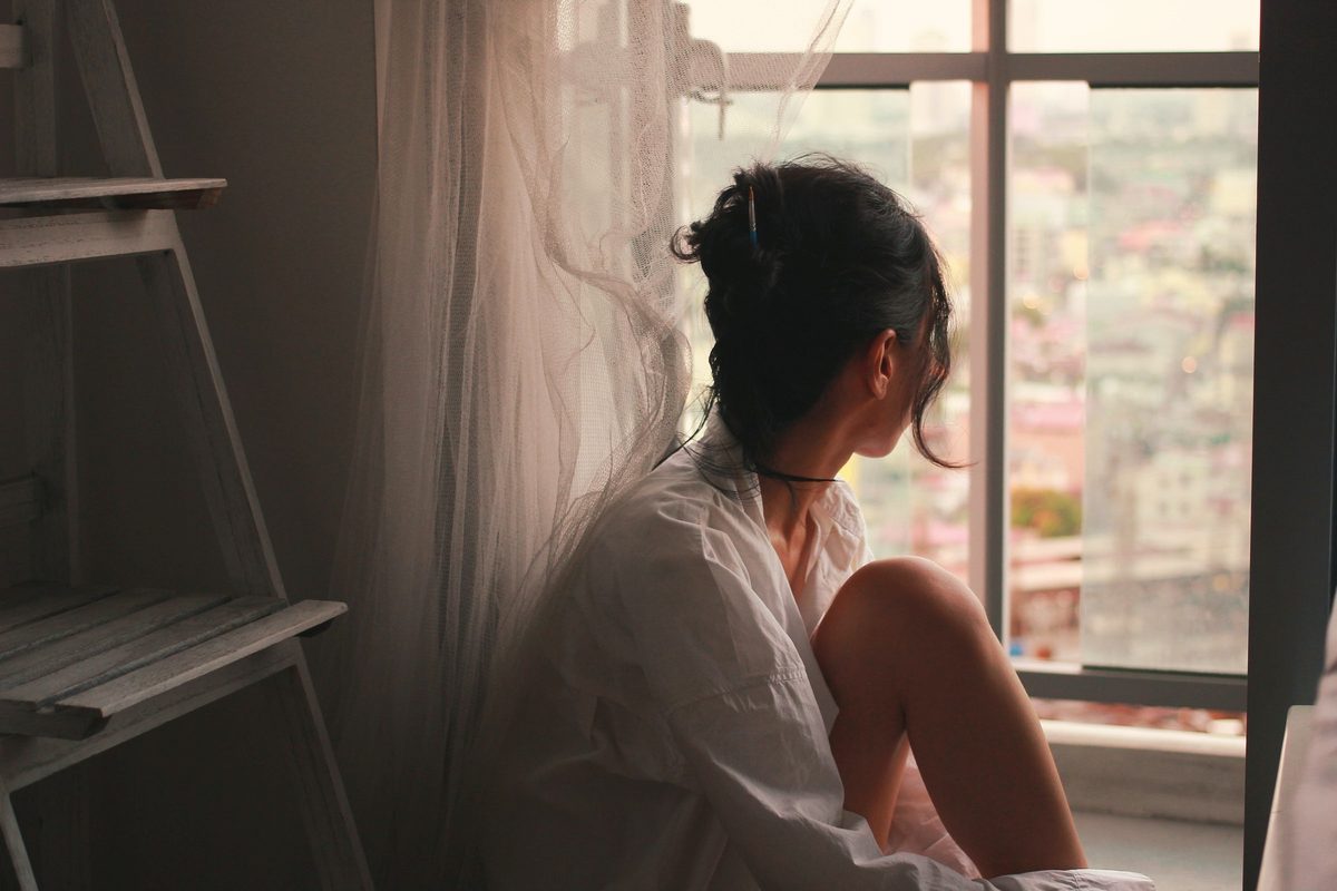 Woman looking out of window