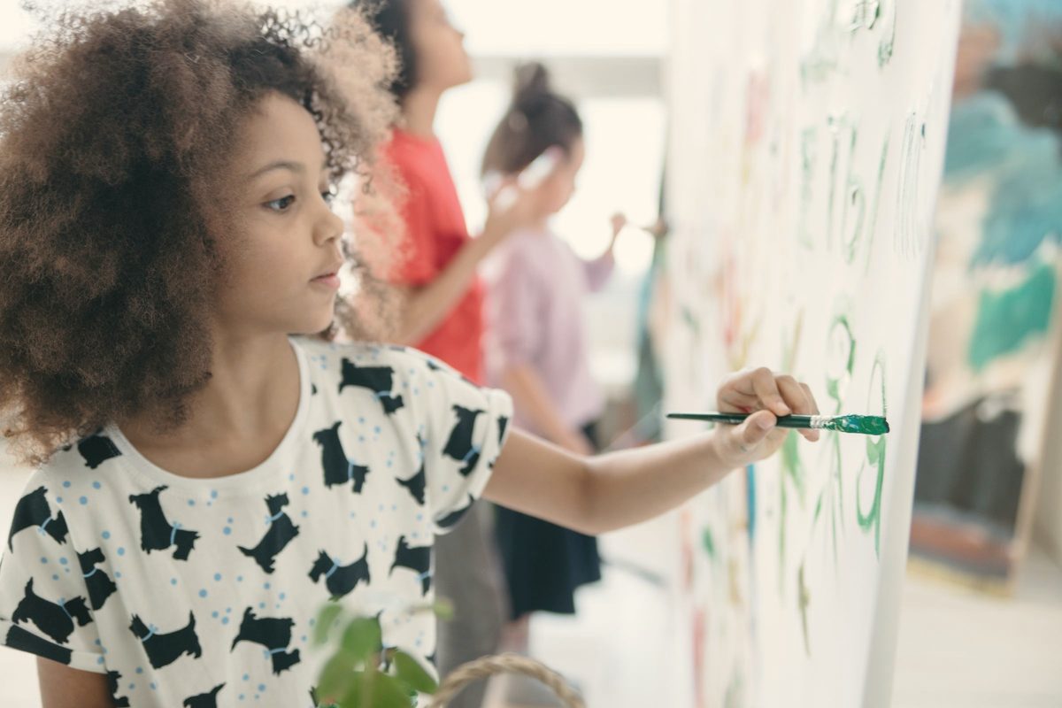 Young woman painting on a canvas