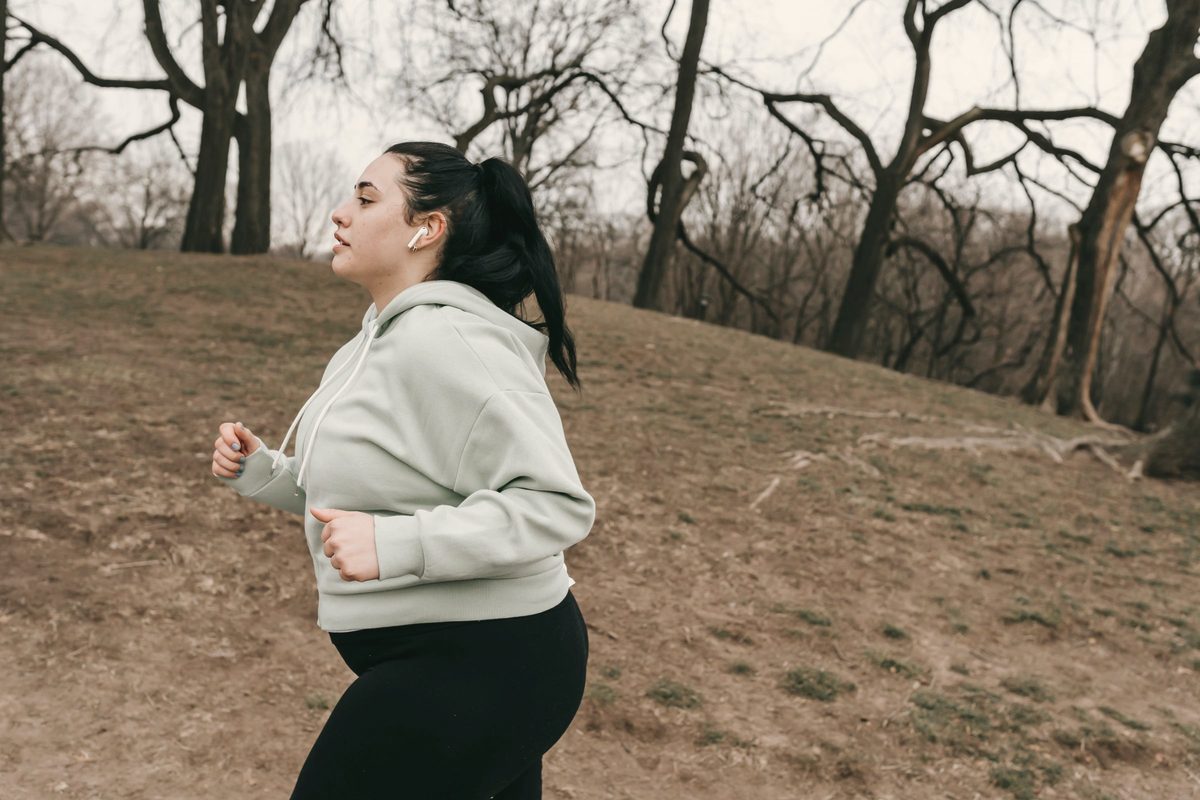 Woman jogging through a park