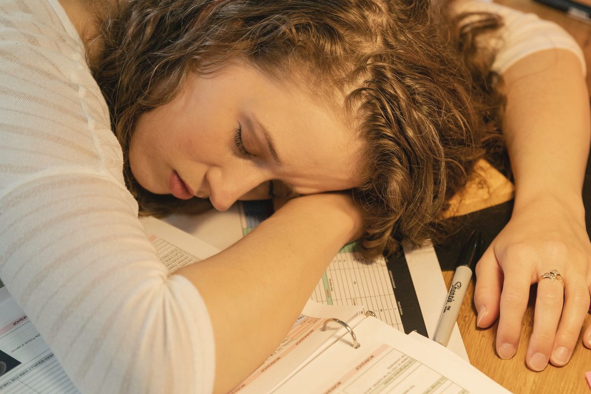 Tired woman sleeping on desk