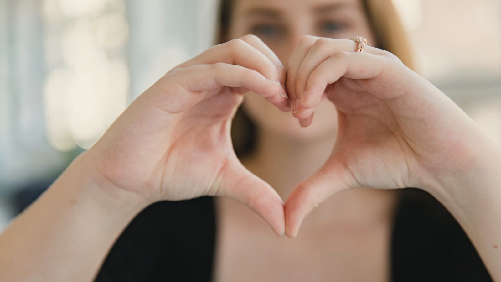 Woman making a heart shape with her hands