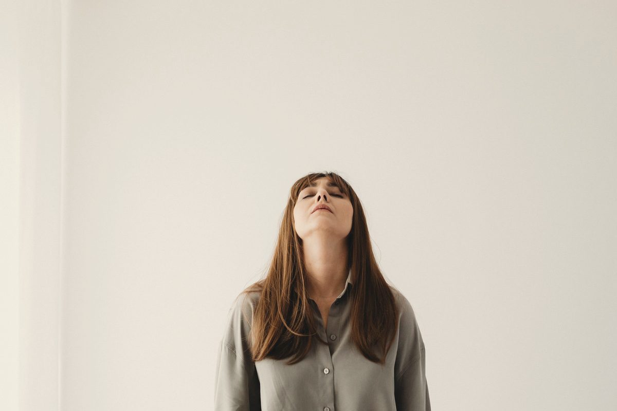 Portrait of a woman with her eyes closed against a white background