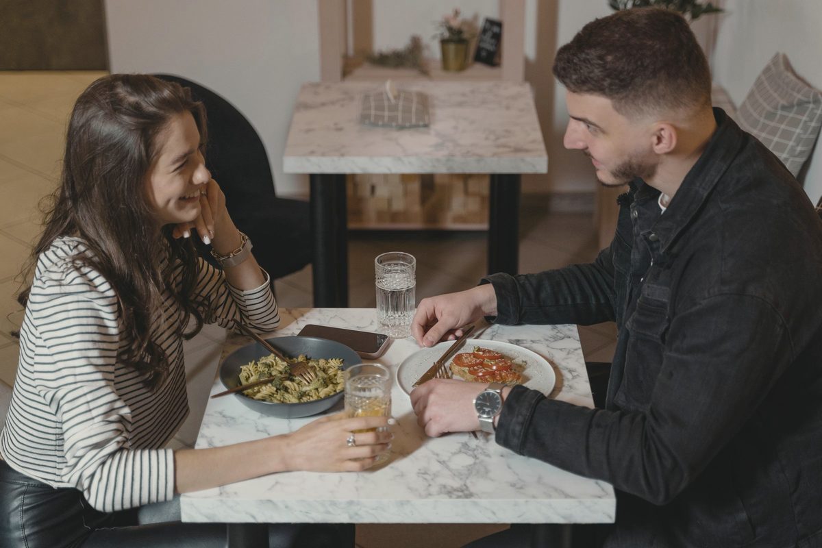 Man and woman eating a meal at a table
