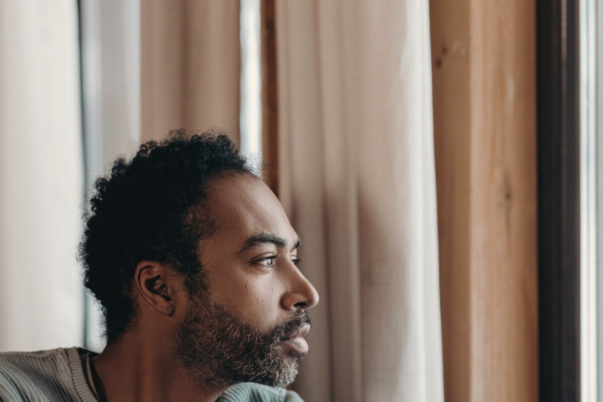 A man sitting on a sofa by a window