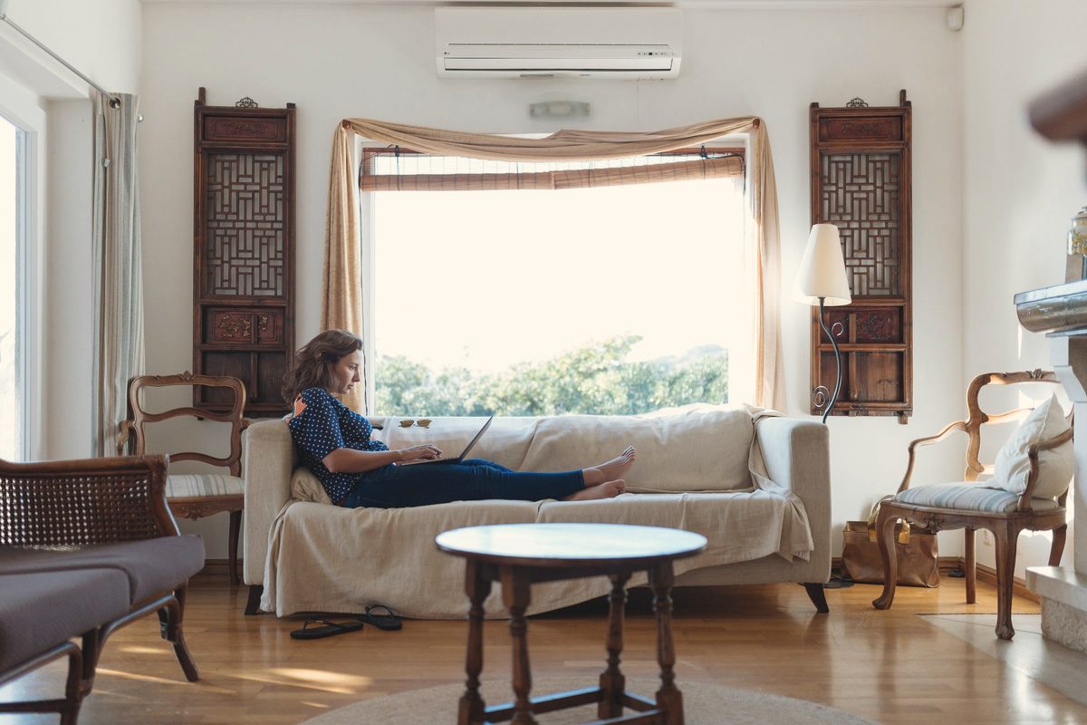 Woman sitting on sofa in living room