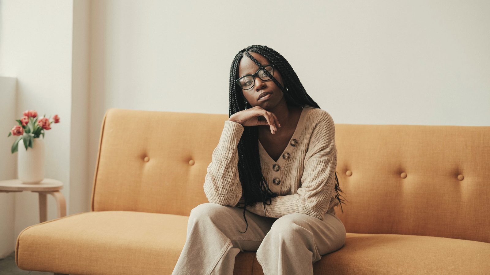 Thoughtful woman sitting on a sofa
