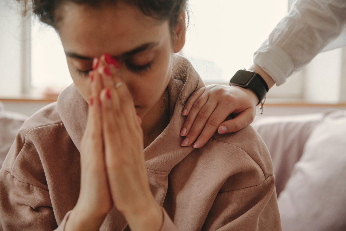 Woman being comforted by a friend