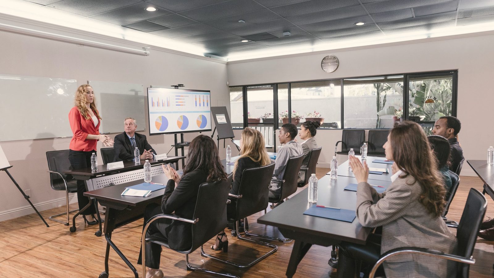 Woman presenting to colleagues in a meeting room