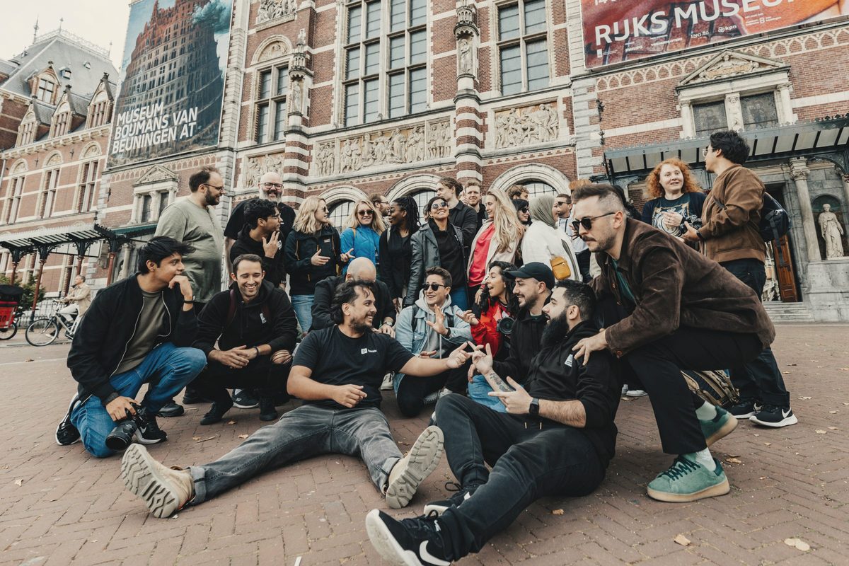 Group of smiling friends sitting together outdoors